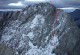 The true summit looks worse than it is. Follow the gully (left of the red line) up and then go along the crest.